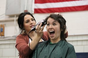Sophomore Nathalie Solorio getting her hair buzzed off at the St. Baldrick's event for childhood cancer research