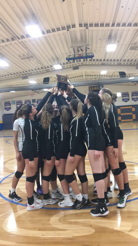 The Pattonville girls' volleyball team holds up the District championship trophy after their 2-0 victory against Hazelwood West on Oct. 25.