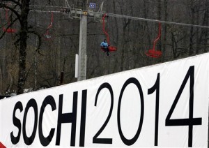 A skier rides on a ski lift past a billboard promoting the bid to host the 2014 Winter Olympic Games in the Russian resort of Krasnaya Polyana during a visit by International Olympic Committee inspectors in the Krasnaya Polyana area outside the Black Sea resort of Sochi, southern Russia, in this Wednesday, Feb 21, 2007, file photo. Sochi is competing against Salzburg, Austria, and Pyeongchang, South Korea. One bid offers a traditional Alpine setting in the heart of Europe. Another promises a unique coastal and mountain layout on the Black Sea. A third trumpets the opening of a winter sports frontier in Asia. The International Olympic Committee is faced with three very different proposals for the 2014 Winter Games, and there is no telling which will prevail as the bid campaign enters its final days. (AP Photo/ Mikhail Metzel, File)