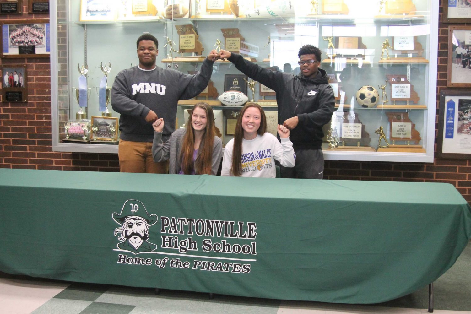 Four student-athletes sign to play sports in college