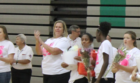 Ms. Becky Middendorf applauds the 2016 seniors as they are recognized during the girls volleyball senior night.