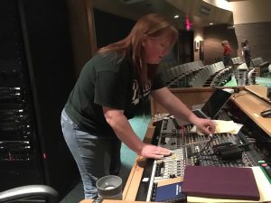 Ms. Jen Wasmer works the sound board during the Mr. PHS show on Friday, Feb. 19.