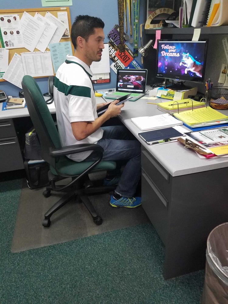 Mr. Patrick Handrahan works in his office in the counseling department.