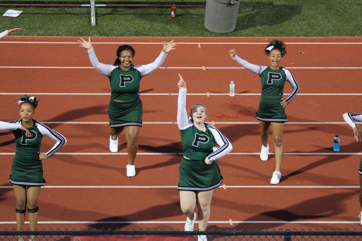 JV cheerleaders were on the track during Homecoming football game