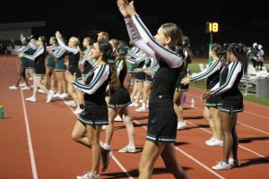 Varsity and JV cheerleaders cheer on the Pattonville football team during the Homecoming game on Sept. 23.