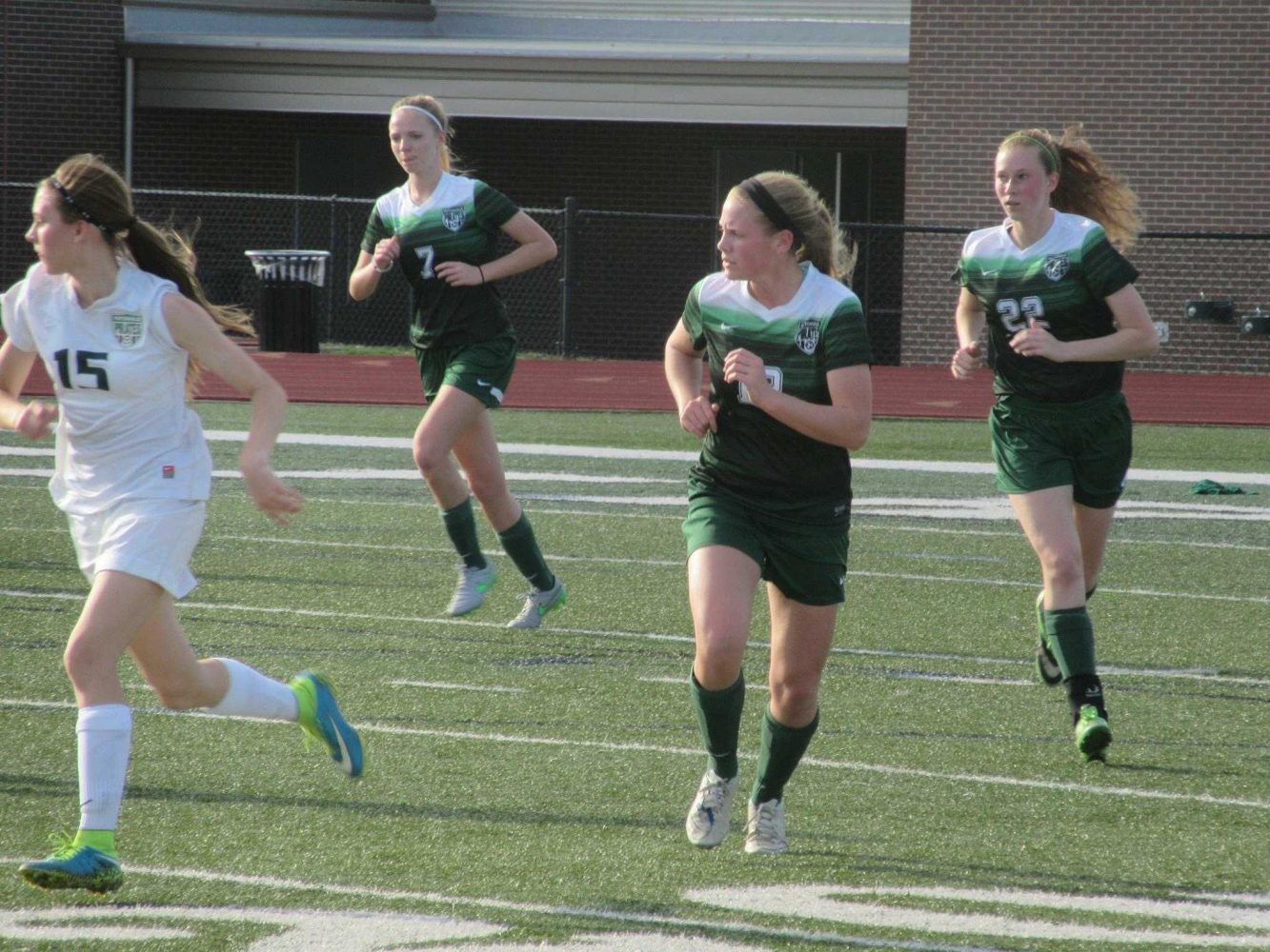 McGehee (back right) runs up the field with fellow teammates Bailey Schaefermeier (center) and Kayla Meyer (back left)