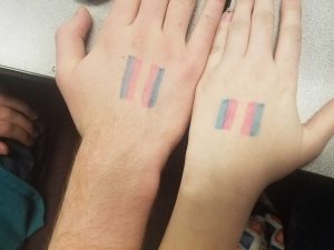 Students draw transgender flags on their hands to silently protest the Bathroom Bill