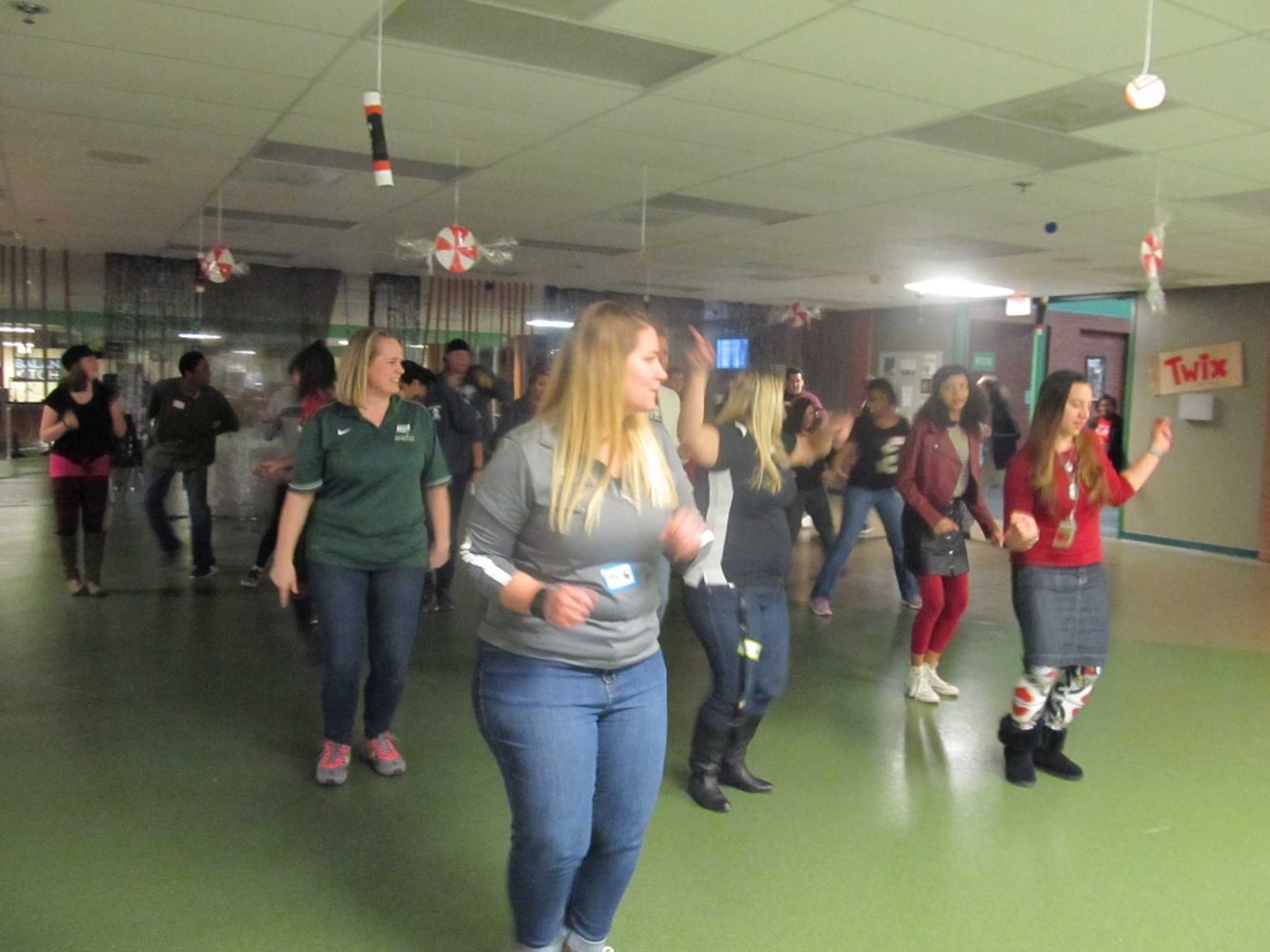 Students and teachers dance together in the cafeteria during the Night to Shine event.