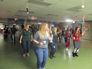 Students and teachers dance together in the cafeteria during the 'Night to Shine' event.
