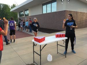 Roma Patel winds up to throw the ping pong ball in a game of Cup Bong.