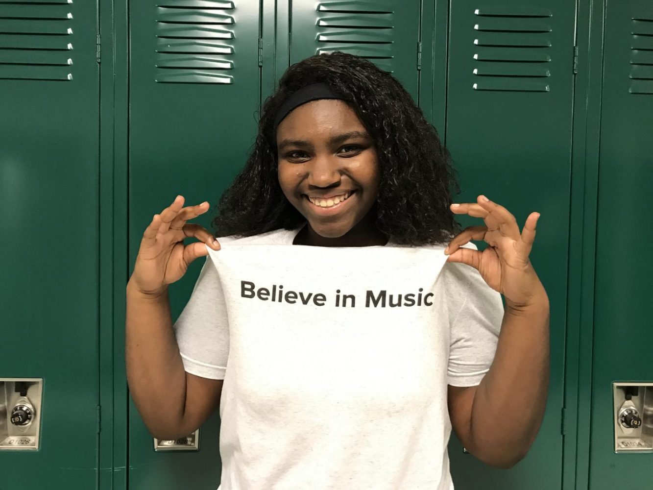 Raven Hayes shows off the shirt she received at Grammy Camp