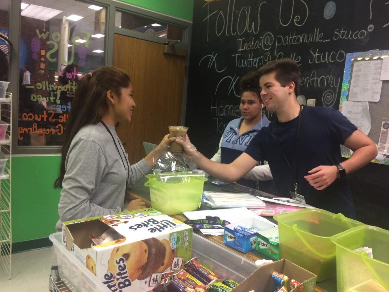Daniel Shor, STUCO Store manager, serves coffee to student. 