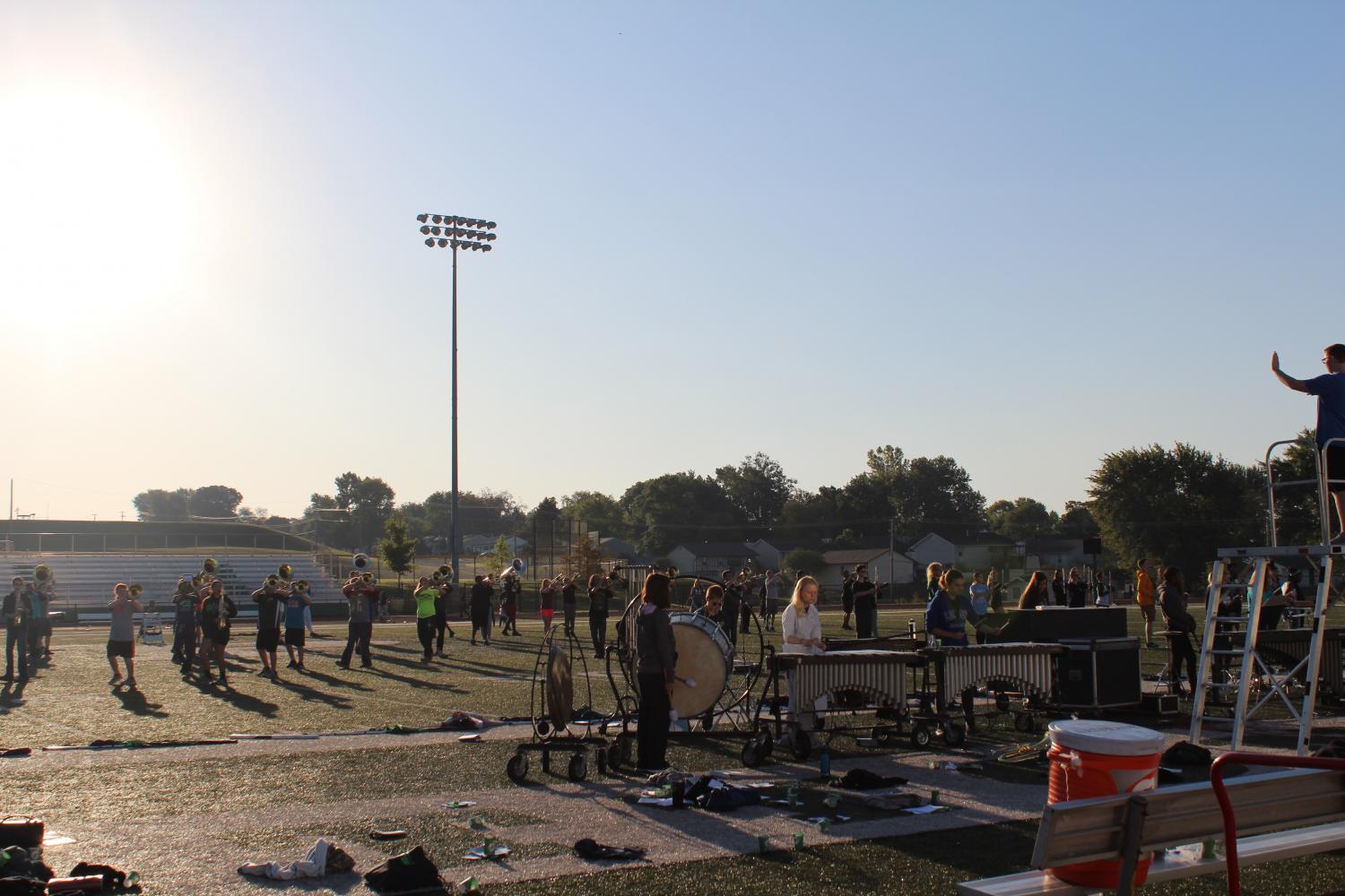 The marching band practices during 1st hour out at the football stadium during class. (File photo)