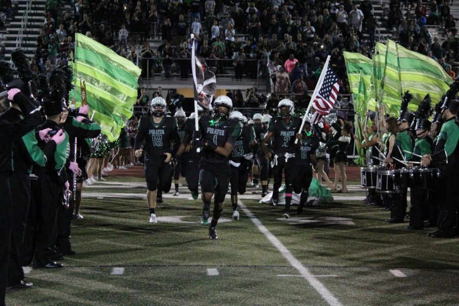 The football team runs onto the field before the homecoming game on Oct. 13.