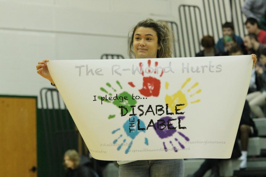 Senior Katie Hutchison-Dibello holds the sign in front of the PHS student body during the assemblies.