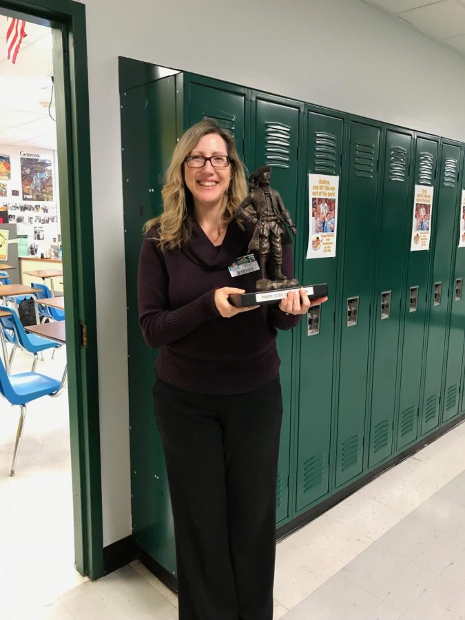 Mrs. Frerker posing with Pirate Pete trophy after being named this weeks Pirate Code staff winner.