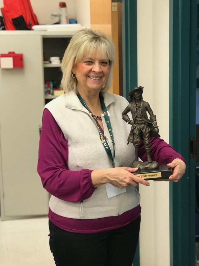 Mrs. Harget posing with the Pirate Pete trophy after being announced this weeks Pirate Code Staff Winner.