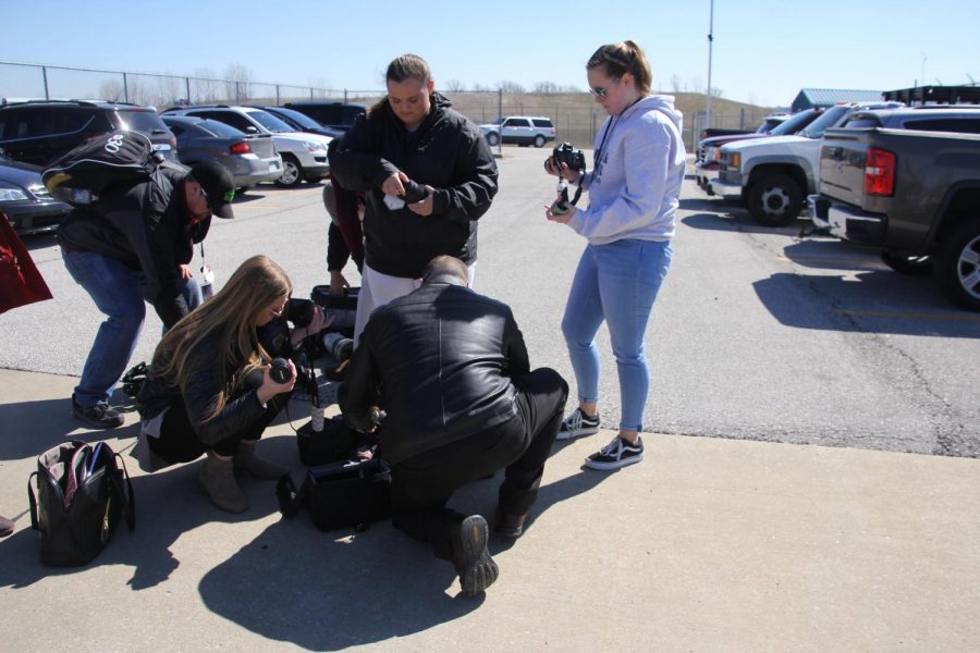 Student reporters go through security and have their equipment checked before getting shuttled to the press area. 