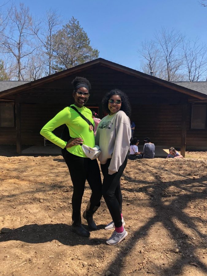 Camp Councelors Teoni Walker and Kelsey Van Hook pose outside of girls cabins.