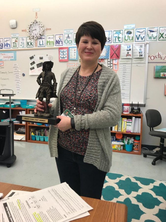 mrs. Parish posing with the Pirate Pete Trophy.