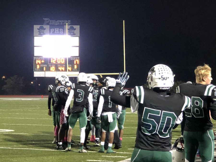 Pattonville players hold up four fingers to signal the start of the 4th quarter in the playoff game against Marquette High School.
