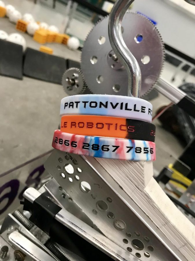 The Robotics team is selling wristbands to help raise money for the club.