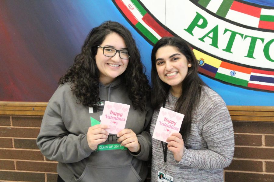 Aliza Ahmed and Amna Saeed holding the Carntation Cards 