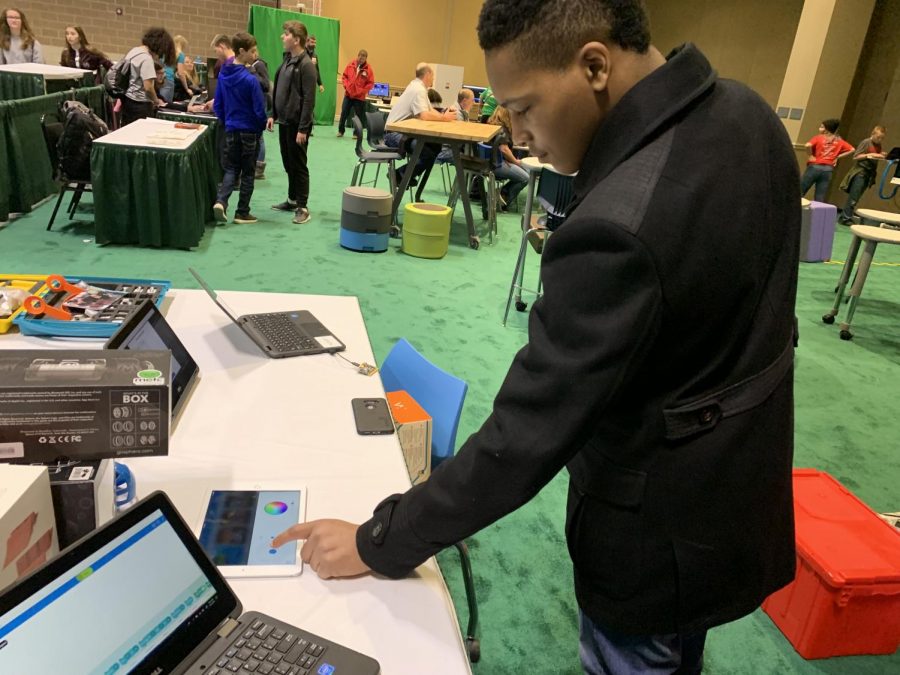 Cornel Childs Jr. is using a tablet to control the robot. 