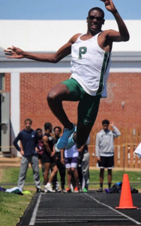 Senior Michael Jackson competes in a jumping event during a track meet. 