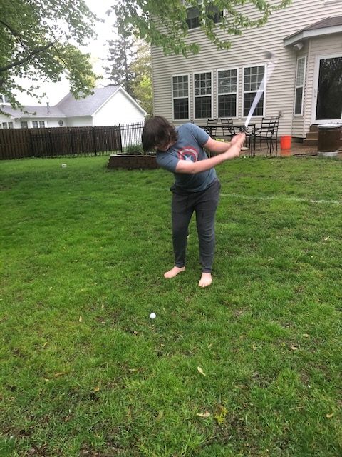 Practicing his swing in the yard, Thomas Clifford still finds a way to develop his skills.