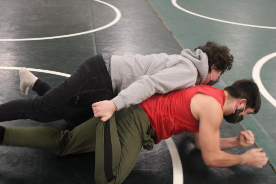 Pattonville High School Senior, Noah Rosebaugh,  takes down his opponent to the ground trying to grab his leg and pin him. 