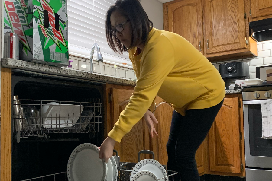 Mrs. Miller does the dishes while on a brief break from her work.