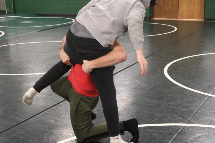 Junior Pattonville Student  Tim Shaefer tries to take down his opponent. Having the right technique, he is going for the pin after.  