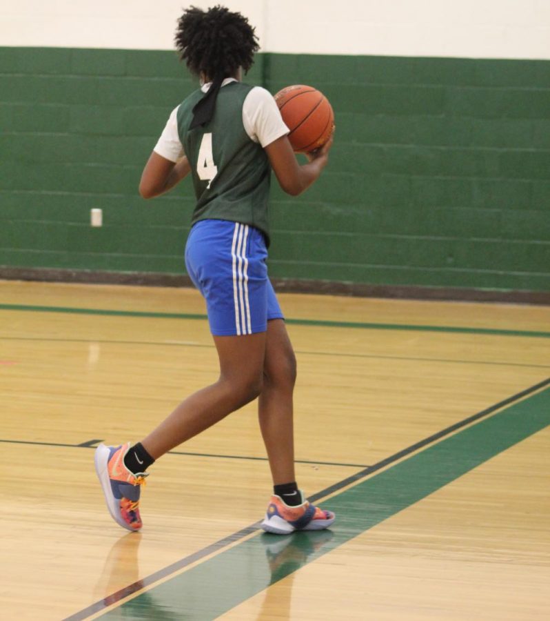Sophomore Jnyla Bush gets into position during the JV-Varsity scrimmage. Varsity went on to win, but the players reported it was good practice for the upcoming game.