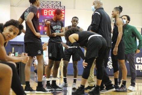 Varsity players Levi Banks, Kellen Thames, Alijah Carter, Justin Coleman, and Jonathan Cosby having timeout with head Coach Kelly Thames and assistant Coach Travis Harris  to see what their next play of action is. Sophomore Tory Allen has a  conversation with a fellow teammate.    