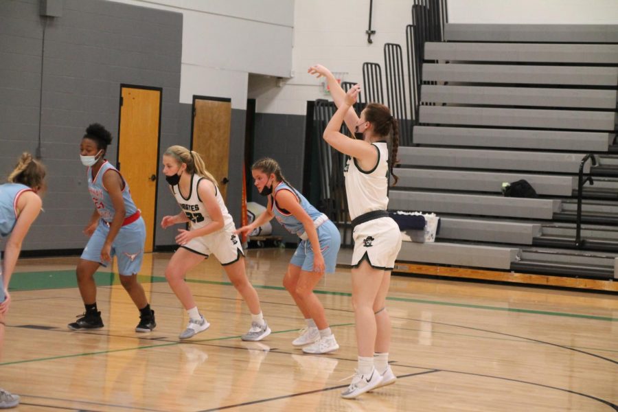 Charlie Heiligenstein throws a free throw in Pattonvilles home game against Parkway West on December 11, while Mattie Ohlsen gets ready to catch the rebound. 