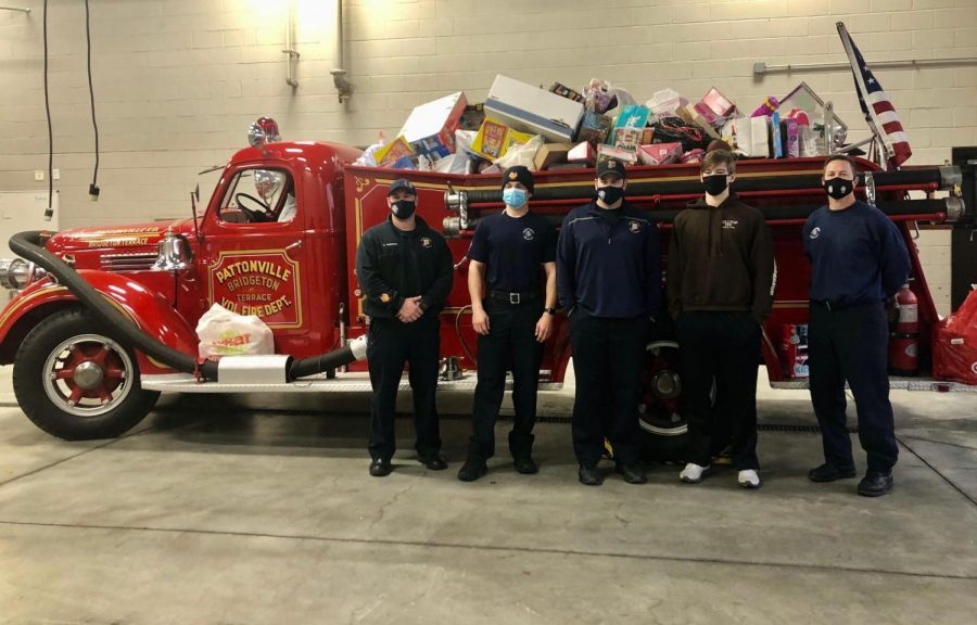 Jaxon Luraschi with Pattonville Firefighters. The Pattonville Community donated over 100 toys, filling the fire truck.