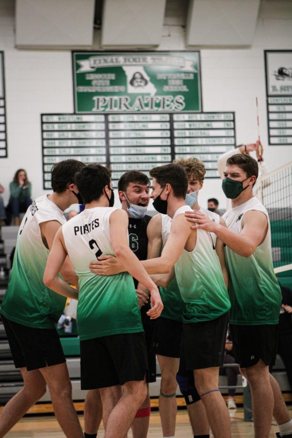 After a point-winning kill, Zach Noles is congratulated by his teammates. The Varsity Boys' Volleyball Team is currently undefeated, with a 28-0 record.