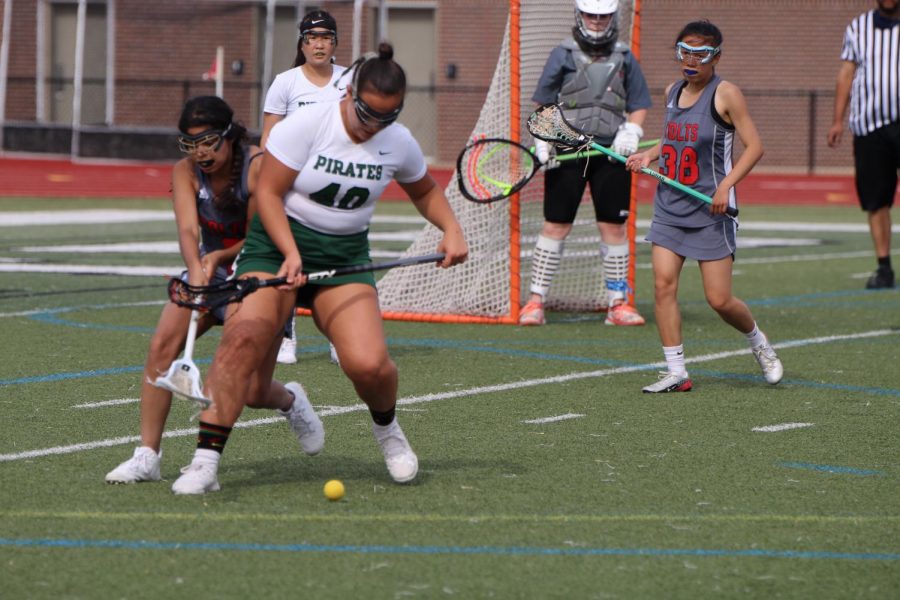 Sophie Zegar (12) works towards scoring for her team. She is a captain of the lacrosse team. 
