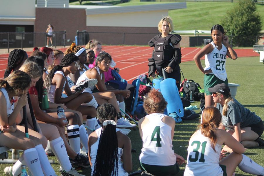 Field hockey coach Jessica Hale talks with the team after the first quarter of their game, where she critiques the players on what they’re doing well and what they need to work on. The team has had to compromise on the positions each player plays considering the recent drop in numbers. Brand new players are having to play at a varsity level because of it. Captain Lauren Barton said, “Our team as a whole is way smaller compared to a normal year, and the newer players are getting thrown into a higher level game which can be really hard on them.