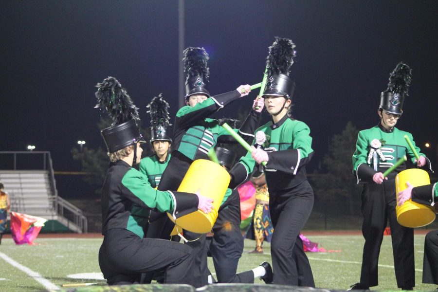 The band members performs their show at the last home football game of the season. Mia Baugher, Madelyn Condado, Caitlin Dermody, Holly Jones and Nora Scharer performed the bucket drums toward the end of the show.