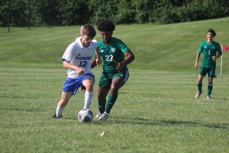 Noeal Arefaine fights a Duchesne player for the ball in the game on September 7. The Pirates went on to win, 2-0.
