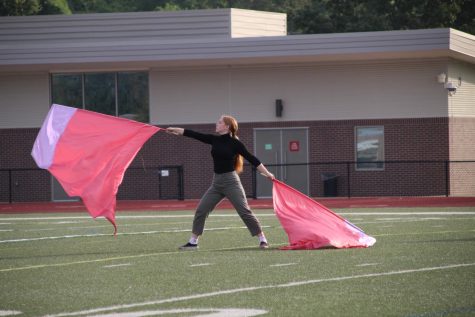 Camille Lofland practices her homecoming routine.  Lofland, a senior, joined Winter Guard for the first time after Color Guard season ended.
