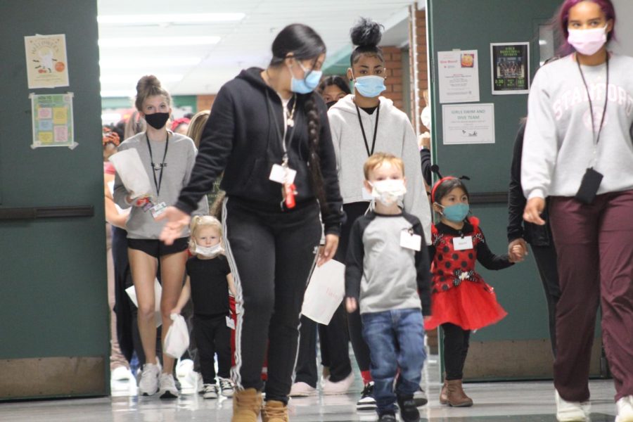 Child Development II students walk with their playschool kids in the annual fall walk. 