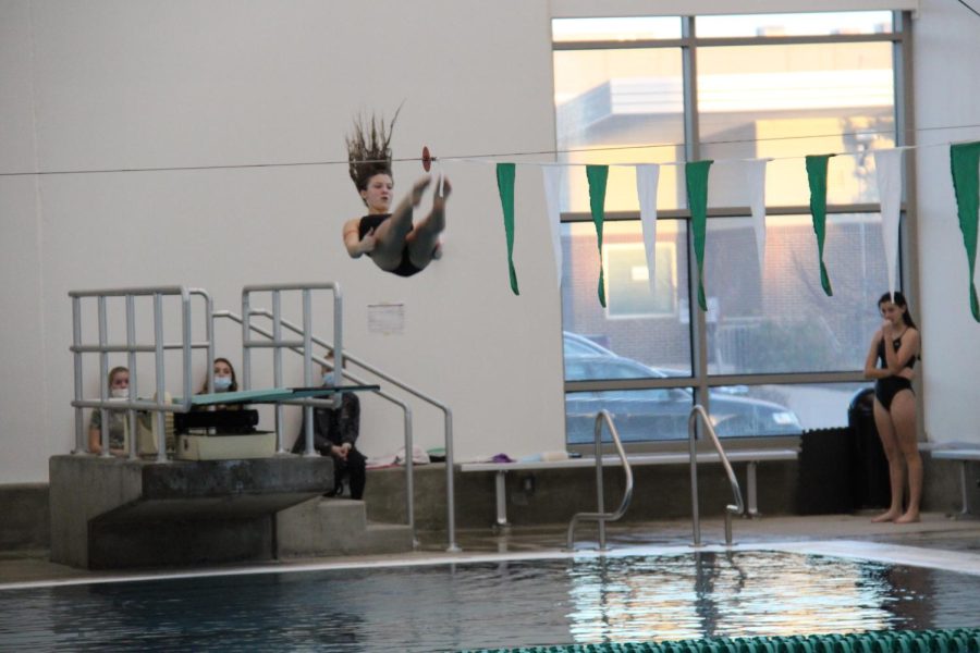 Alana Byers performs a front flip in the competitive diving portion of the swim meet on December 3rd, 2021. 