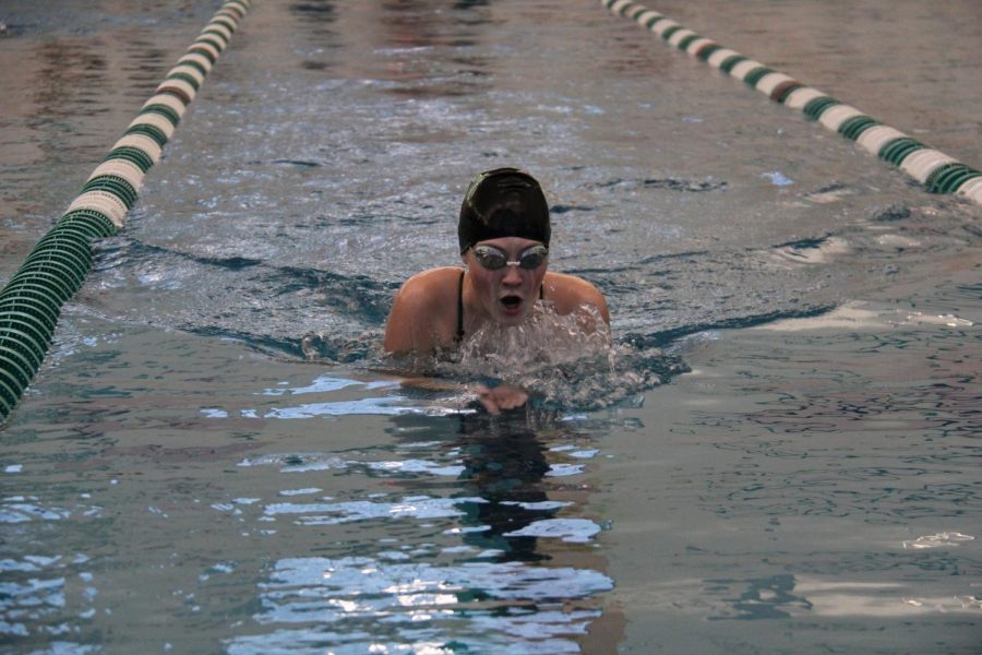 Tehya CoxPotter emerges from the water to take a breath of air in a  competitive swim meet against Oakville High School. CoxPotter competed in the breast stroke on senior night, January 18, 2022.