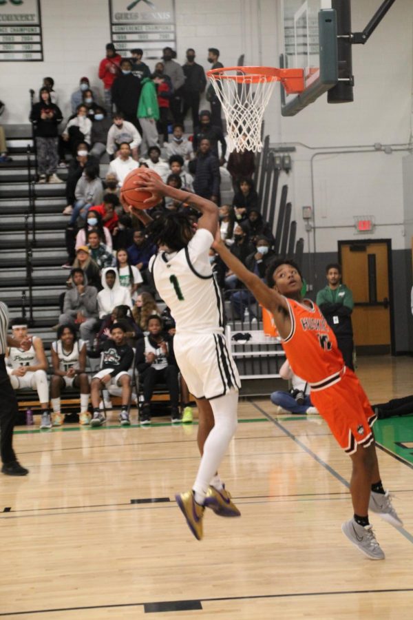 Player #1 Ronnell Johnson Jr. tries to shoot and make the basket during the February 22 game against Ritenour High School. The Pirates won that game, with a score of 72-39.