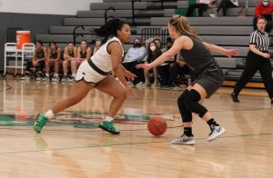 Taylor Montgomery making her way past her Holt defender, passes it to Jasmine Gray. Jasmine Gray passes it to Zoe Newland, then Zoe Newland drives for a layup and comes up short. 