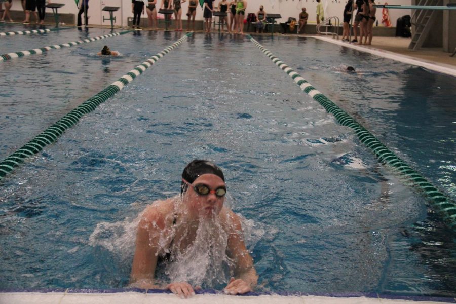 Emma Eiswirth does a breast stroke backturn in the meet against Oakville on January 18, 2022 during senior night.
