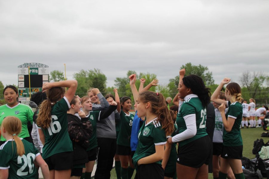 The JV soccer team huddles together and chants before they start their match against MICDS on May 3.